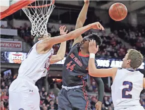  ?? RICK WOOD/MILWAUKEE JOURNAL SENTINEL ?? Brookfield East’s Patrick Cartier slaps away a shot by Sun Prairie’s Marlon Ruffin during a Division 1 semifinal Friday night.