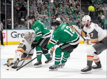  ?? The Associated Press ?? Vegas Golden Knights goaltender Adin Hill gets help defending the net from Alex Pietrangel­o as Dallas Stars centre Radek Faksa takes a shot during the third period of Game 3 of the NHL hockey Stanley Cup Western Conference finals, Tuesday.