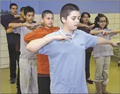  ??  ?? When they’re not getting schoolwork done, Phipps Academy students work a little on their dancing skills. The center is slated to close in July.