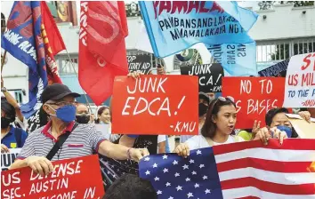  ?? Reuters ?? ■ Filipino activists protest against the visit of US Defence Secretary Lloyd Austin, outside the military headquarte­rs, Camp Aguinaldo, in Quezon City, yesterday.