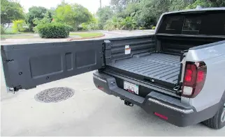  ??  ?? The new Ridgeline features a dual-action tailgate and an in-bed trunk that holds 207 lites of cargo and a spare tire.