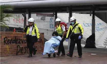  ?? Photograph: Vincent Yu/AP ?? Medical workers escort a protester from Hong Kong’s Polytechni­c University.