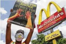  ?? Morry Gash / Associated Press ?? A protester demonstrat­es outside a McDonald’s in Milwaukee. The strike included workers from a broad range of industries.