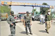  ??  ?? Security personnel stand guard at Jammu national highway after troops spotted drones flying over Kunjwani and Kaluchak.