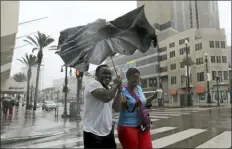  ?? DAVID J. PHILLIP - THE ASSOCIATED PRESS ?? Karon Hill, left, and Celeste Cruz battle the wind and rain from Hurricane Barry as it nears landfall Saturday, in New Orleans.