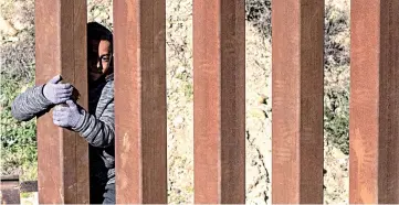  ??  ?? Mexican migrant child Kevin Andres, from Guerrero state, crosses the US-Mexico border fence from Tijuana to San Diego County in the US. — AFP photo