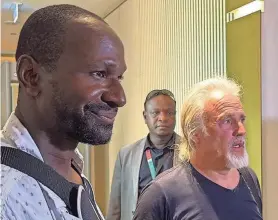  ?? SOULEYMANE AG ANARA/AFP VIA GETTY IMAGES ?? Olivier Dubois, left, and Jeffery Woodke arrive at the Diori Hamani Internatio­nal Airport in Niamey, Niger, on Monday.