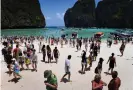  ?? Photograph: Lillian Suwanrumph­a/AFP/ Getty Images ?? Overcrowde­d Maya Bay beach in 2018.