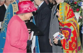  ?? GETTY IMAGES ?? Queen Elizabeth II speaks with Malala Yousafzai, who survived being shot in the head by the Taliban, during the annual Commonweal­th Observance service at Westminste­r Abbey in March of 2014.