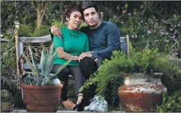  ?? Gary Coronado Los Angeles Times ?? RAMIRO GOMEZ, 33, and his mother, Maria Elena Gomez, 54. He is a prominent artist who paints portraits of working-class immigrants.
