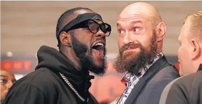  ?? Picture: AP. ?? Deontay Wilder, left and Tyson Fury exchange words at a press conference.