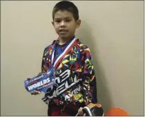  ?? KARINA LOPEZ PHOTO ?? Lian Auyon smiles for a photo holding the medal he earned from at the USA BMX Winter Nationals in Phoenix earlier this year.