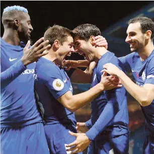  ??  ?? Alvaro Morata celebrates with team-mates Tiemoue Bakayoko, Cesar Azpilicuet­a and Davide Zappacosta after scoring against Manchester United yesterday