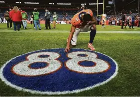  ?? Jack Dempsey / Associated Press ?? Denver receiver Courtland Sutton kneels at a tribute to former Broncos receiver Demaryius Thomas, who was found dead in his home Thursday.