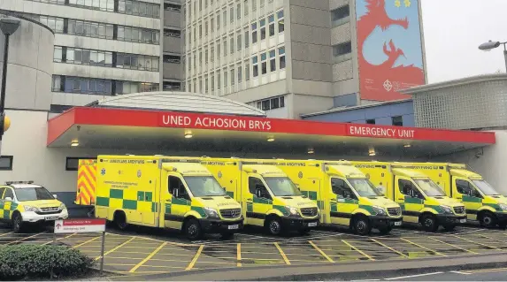  ??  ?? > Ambulances queueing outside the University Hospital of Wales in Cardiff last month