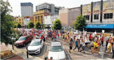  ?? AP PHOTO/BUTCH DILL ?? Protesters for women’s rights march in Montgomery, Ala., on Sunday to the Alabama Capitol to protest a law passed last week making abortion a felony in nearly all cases with no exceptions for cases of rape or incest.