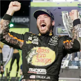  ?? (Photo by Terry Renna, AP) ?? Martin Truex Jr. celebrates in Victory Lane after winning the NASCAR Cup Series auto race and season championsh­ip.