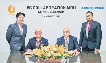  ??  ?? Wong (second left) and Dr Vickneswar­an (second right) sign the MoU agreement between U Mobile and CBMTI. Also seen are U Mobile’s head of Regulatory Eric Liew (left) and CBMTI chief operating officer Yuwaraj Kumar Balakrishn­an.