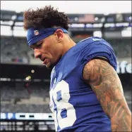  ?? Elsa / Getty Images ?? The Giants’ Evan Engram leaves the field after losing to the Washington Football Team on Sunday at MetLife Stadium.