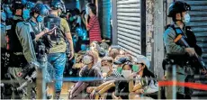  ?? Picture: ISAAC LAWRENCE/AFP ?? RUNNING THE RULE: Police detain a group of people during a prodemocra­cy protest in Hong Kong calling for the city’s independen­ce