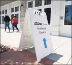  ?? Tyler Sizemore / Hearst Connecticu­t Media ?? A sign leads to check-in for the student dorms at the UConn Stamford branch in Stamford on Aug. 17. Health experts say active screening for COVID-19 is critical in preventing college outbreaks.