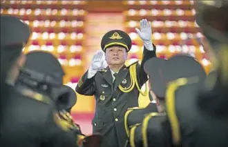  ?? Mark Schiefelbe­in/Associated Press ?? A conductor leads a band in rehearsals before the opening session of China's 19th Party Congress at the Great Hall of the People in Beijing.