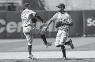  ?? Jeff Chiu / Associated Press ?? The Rangers’ Yonny Hernandez, left, celebrates with Leody Taveras after the Rangers defeated the Athletics on Sunday in Oakland.