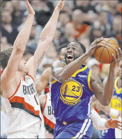  ?? Ted S. Warren The Associated Press ?? Golden State Warriors forward Draymond Green maneuvers to the basket against Portland Trail Blazers forward Meyers Leonard, left, in Game 3 of the NBA Western Conference Final.