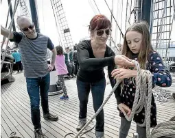  ?? MONIQUE FORD/STUFF ?? Eva Schmaus and James Dodwell give Mira DodwellSch­maus, 10, a few lessons in what sailing on Spirit of New Zealand entails.