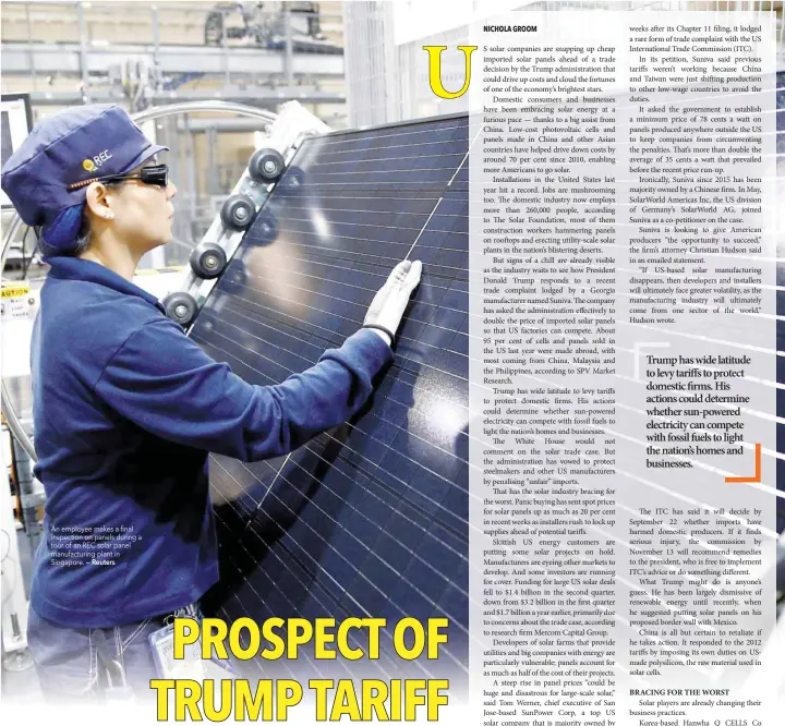  ?? — Reuters ?? An employee makes a final inspection on panels during a tour of an REC solar panel manufactur­ing plant in Singapore.