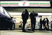  ?? Chris Carlson Associated Press ?? IMMIGRATIO­N agents serve an employment audit notice last week at a 7-Eleven store in Los Angeles.