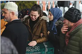  ?? AP/EMRAH GUREL ?? Relatives grieve Saturday in Istanbul during funeral prayers for nine members of a family killed in the collapse of an apartment building Wednesday. Turkish officials at the service blamed illegal constructi­on practices for the collapse that so far has claimed 18 lives.