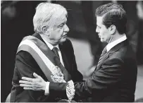  ?? Ronaldo Schemidt / AFP / Getty Images ?? Mexico’s outgoing President Enrique Pena Nieto, right, greets López Obrador, who won Mexico’s July 1 election in a landslide.