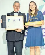  ??  ?? THE HEAD of retail distributi­on and Orbis client servicing at Allan Gray, Tamryn Lamb, receives the Raging Bull Award for the South African Company of the Year (2018) from Martin Hesse, the content editor of Personal Finance.