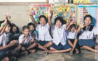  ??  ?? Migrant children learn about safe migration through interactiv­e games at a Migrant learning centre in Ranong.