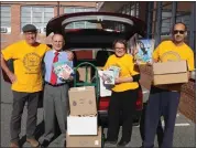  ?? SUBMITTED PHOTO ?? From left, Bob Bauers, John Armato, Sandy Bauers and Johnny Corson display some of the books the NAACP’s Road to Reading program is dropping off at the Pottstown School district administra­tion building.