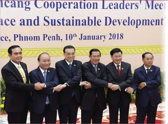  ?? Photo :AFP ?? (Left to right) Thai Prime Minister Prayut Chan-o-cha, Vietnam's Prime Minister Nguyen Xuan Phuc, Chinese Premier Li Keqiang, Cambodian Prime Minister Hun Sen, Laos' Prime Minister Thongloun Sisoulith and Myanmar Vice President Myint Swe link arms...