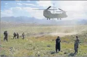  ?? AFP/FILE ?? A US military Chinook helicopter lands on a field outside the n
governor's palace in Maidan Shahr, Afghanista­n.