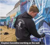  ??  ?? Stephen Considine working on the wall