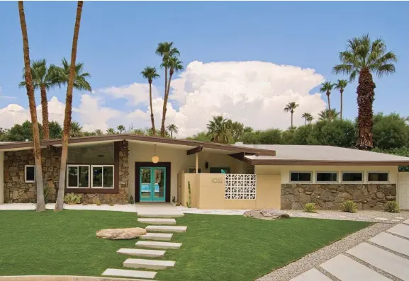  ??  ?? “WHEN YOU LOOK AT THE HOUSE, YOUR EYES ARE DRAWN TO THE BRIGHT COLOR OF THE ‘POOL PARTY’ BLUE AND IT DRAWS YOU IN. AND THE STEPS LEADING UP ALSO PULL YOUR EYES TOWARD THAT FOCAL POINT,” KEVIN SAYS. TO TIE IN THE ROCK WORK, A DARKER BROWN COLOR WAS USED FOR THE TRIM.