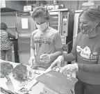  ?? KATHY YOUNG/ AP ?? HealthBarn Foundation workers carve a turkey that will be frozen and packaged into meals for seniors in Hawthorne, New Jersey.