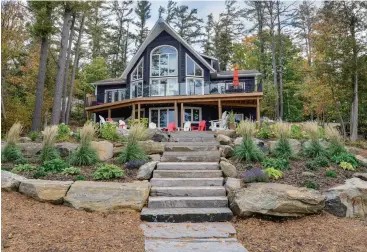  ?? ROYAL LEPAGE LAKES OF MUSKOKA – CLARKE MUSKOKA REALTY ?? This 3,900-square-foot cottage in Gravenhurs­t in Lake Muskoka was listed this spring at $3.495
million. Granite steps lead to the lakefront, which offers deep water off the docks.