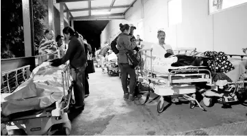  ??  ?? Patients and family members are seen outside the Institute for Social Security and Services for StateWorke­rs (ISSSTE) after an earthquake struck off the southern coast of Mexico in Puebla, Mexico. — AFP photo