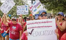  ?? JAY JANNER / AMERICAN-STATESMAN ?? Alyssa Kubiak-Marburger, a teacher from Rockdale, participat­es in a rally at the Capitol on July 17. Democrats and rural GOP House members oppose a private school choice system, while top Republican­s support it.