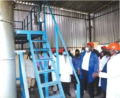  ??  ?? Mr Lufeyi Shato (right) shows a mine boiler tank to Mines and Mining Developmen­t Minister Winston Chitando (second from right) and other Government officials during the official opening of Chikonga Mine on Wednesday. —Picture: Tinai Nyadzayo