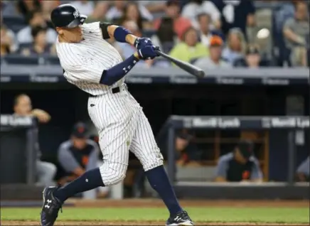  ?? KATHY WILLENS — THE ASSOCIATED PRESS FILE ?? In this file photo, New York Yankees’ Aaron Judge hits a solo home run during the fifth inning of a baseball game against the Detroit Tigers at Yankee Stadium in New York. Aaron Judge of the Yankees and Cody Bellinger of the Dodgers are favored to win...
