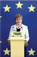  ??  ?? Useless: Nicola Sturgeon on EU flag