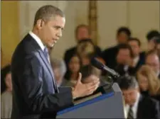  ?? Associated Press ?? President Barack Obama gestures as he answers a question during a news conference in the East Room of the White House in Washington, Wednesday. The president touched on various topics including the widening sex scandal, UN Ambassador Susan Rice and...