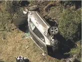  ?? Associated Press ?? In this aerial image take from video provided by KABCTV video, a vehicle rest on its side after an accident involving Tiger Woods in Palos Verdes (Los Angeles County).