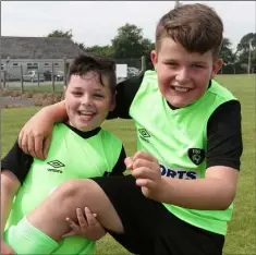  ??  ?? Davy Cullen and Tadhg McGrath having fun at the soccer summer camp at All Blacks AFC.